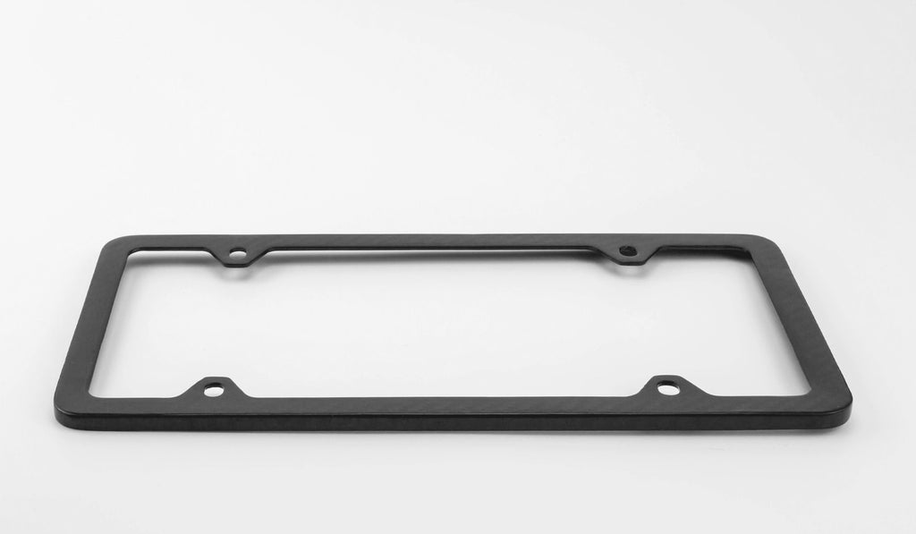 Side view of the Ultimate Carbon Fiber License Plate Frame against a white background matte version